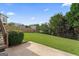Lush backyard with a stone patio and well-maintained lawn and landscaping at 375 Oakpark Ter, Mcdonough, GA 30253