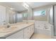 Bright bathroom featuring double sinks, soaking tub, and walk-in shower at 375 Oakpark Ter, Mcdonough, GA 30253