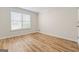 Bedroom with wood-look flooring and a large window for natural light at 375 Oakpark Ter, Mcdonough, GA 30253