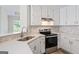 Close up of modern kitchen with white cabinets and stainless steel appliances at 375 Oakpark Ter, Mcdonough, GA 30253