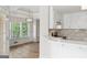 Modern kitchen connected to the breakfast nook, with white cabinets and stainless steel appliances at 375 Oakpark Ter, Mcdonough, GA 30253