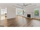 Spacious living room with new wood floors, fireplace, modern ceiling fan, and trey ceilings at 375 Oakpark Ter, Mcdonough, GA 30253