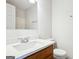 Bathroom featuring a vanity with a marble countertop, ample mirror and modern fixtures at 2047 Charter Ln, Lithonia, GA 30058