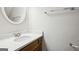 Bathroom with vanity with marble countertop, chrome faucet and oval mirror at 2047 Charter Ln, Lithonia, GA 30058