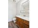 Bright bathroom features a wood vanity with a marble countertop and a framed mirror at 2047 Charter Ln, Lithonia, GA 30058