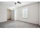 This bedroom features neutral carpet, two windows, and a walk-in closet at 2047 Charter Ln, Lithonia, GA 30058