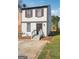 Attractive home with stone details, red shutters, and a quaint gated entrance with fresh landscaping around the property at 2047 Charter Ln, Lithonia, GA 30058