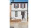 Charming home featuring a distinctive stone facade, red shutters, and a welcoming gated entryway with wooden stairs at 2047 Charter Ln, Lithonia, GA 30058