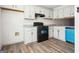 Spacious kitchen showcases white cabinets, granite countertops, modern appliances, and appealing laminate flooring at 2047 Charter Ln, Lithonia, GA 30058