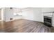 Spacious living room features updated flooring, a classic fireplace, and access to a modern kitchenette at 2047 Charter Ln, Lithonia, GA 30058