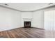 Bright living room boasting sleek laminate flooring, a cozy fireplace, and large sliding glass doors at 2047 Charter Ln, Lithonia, GA 30058