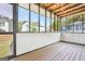 Enclosed sunroom with paneled walls and wood floor, provides an inviting spot to relax at 2047 Charter Ln, Lithonia, GA 30058