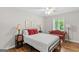 Light-filled bedroom boasts hardwood floors, two side tables, and seating area at 1291 Interlaken Pass, Jonesboro, GA 30238