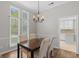 Cozy dining area featuring a chandelier and views of the landscaped yard at 1291 Interlaken Pass, Jonesboro, GA 30238