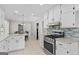 Modern kitchen with white cabinets, granite countertops, and stainless steel appliances at 1291 Interlaken Pass, Jonesboro, GA 30238