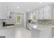 Well-lit kitchen with white cabinetry, tiled backsplash, and stainless steel appliances at 1291 Interlaken Pass, Jonesboro, GA 30238