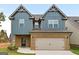 Inviting two-story home with a brick and siding exterior and a two-car garage at 2385 Aukerman Trce # 80, Hampton, GA 30228