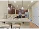 Modern kitchen with granite countertops, stainless steel appliances, and dark wood cabinets at 2385 Aukerman Trce # 80, Hampton, GA 30228