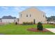 New home's yard. View of the side yard and backyard. Landscaped with grass and pine at 1813 Quaker St, Hampton, GA 30228