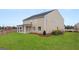New home's lawn. View of the backyard with a covered porch and well-maintained lawn at 1813 Quaker St, Hampton, GA 30228