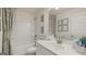 Bright bathroom featuring a shower-tub combo, modern vanity, and decorative accents at 1813 Quaker St, Hampton, GA 30228