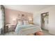 View of stylish bedroom with pink accent wall, decorative pillows, and zebra-striped curtains at 1813 Quaker St, Hampton, GA 30228