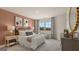 Well-lit bedroom features a rust-colored accent wall, patterned bedding, and patterned curtains at 1813 Quaker St, Hampton, GA 30228