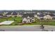 An eye-level aerial view of the lovely home and basketball court with manicured landscaping at 1813 Quaker St, Hampton, GA 30228
