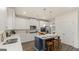 Kitchen with stainless steel appliances, white cabinets, an island with seating and natural light at 1813 Quaker St, Hampton, GA 30228