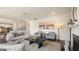 Bright living room boasts an open layout, fireplace, stylish decor and modern ceiling fan at 1813 Quaker St, Hampton, GA 30228