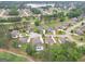 Aerial view of a home in a golf course community with a lake nearby, highlighting the lush surroundings at 3709 Royer Ln # 23, Hampton, GA 30228