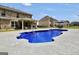 In-ground backyard pool with sunning deck and steps, near outdoor kitchen and covered patio at 3709 Royer Ln # 23, Hampton, GA 30228