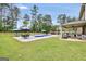 Expansive backyard featuring a sparkling in-ground pool, covered patio, and outdoor kitchen bar at 3709 Royer Ln # 23, Hampton, GA 30228