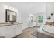 Bright bathroom with double vanity, granite counters, soaking tub, walk-in shower, and natural light at 3709 Royer Ln # 23, Hampton, GA 30228