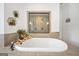 Bright bathroom featuring soaking tub, tiled shower, and plants for decoration at 3709 Royer Ln # 23, Hampton, GA 30228