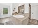 Spa-like bathroom featuring a soaking tub, walk-in shower, and natural lighting at 3709 Royer Ln # 23, Hampton, GA 30228