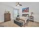 Cozy bedroom features a ceiling fan, city skyline art, and comfortable furnishings at 3709 Royer Ln # 23, Hampton, GA 30228