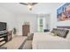 Bright bedroom with neutral carpet, ceiling fan, city skyline art, and a comfortable bed at 3709 Royer Ln # 23, Hampton, GA 30228