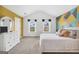 Bright bedroom with a decorative accent wall, a comfortable bed, and two windows at 3709 Royer Ln # 23, Hampton, GA 30228