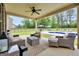 Relaxing covered patio with ceiling fan and cozy wicker furniture overlooking the beautiful backyard pool at 3709 Royer Ln # 23, Hampton, GA 30228
