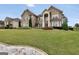 Charming two-story brick home with manicured lawn and decorative landscaping in a suburban neighborhood at 3709 Royer Ln # 23, Hampton, GA 30228