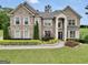 Stunning two-story brick home with meticulously landscaped front yard, columns and covered entryway at 3709 Royer Ln # 23, Hampton, GA 30228