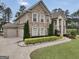 Beautifully landscaped home with a two-car garage and manicured lawn with decorative shrubbery at 3709 Royer Ln # 23, Hampton, GA 30228