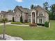 Elegant two-story home with brick facade, manicured lawn, mature trees and a well-maintained landscape at 3709 Royer Ln # 23, Hampton, GA 30228