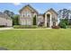 Beautiful brick home featuring a manicured front lawn and lush landscaping at 3709 Royer Ln # 23, Hampton, GA 30228