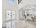 Grand foyer leading to dining room boasts high ceilings, marble floors, and decorative glass doors at 3709 Royer Ln # 23, Hampton, GA 30228