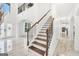 Bright foyer with staircase and marble flooring, leading to the upper level with an open floor plan at 3709 Royer Ln # 23, Hampton, GA 30228