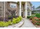 Close-up of an elegant home entrance featuring decorative plants and a well-maintained walkway at 3709 Royer Ln # 23, Hampton, GA 30228