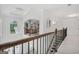 Hallway with decorative chandelier, staircase and wrought iron handrail at 3709 Royer Ln # 23, Hampton, GA 30228