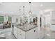 Bright, modern kitchen with stainless steel appliances and an island with granite countertops and pendant lighting at 3709 Royer Ln # 23, Hampton, GA 30228